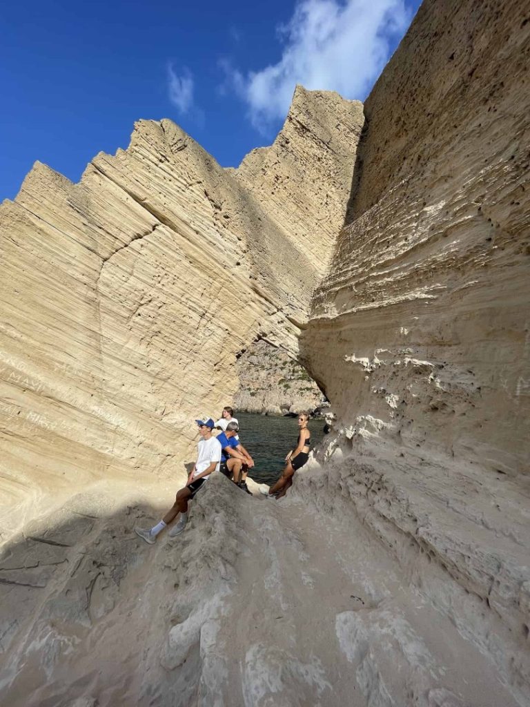 Hikers exploring towering sandstone formations on Ibiza’s unique Legend Hike Station coastal adventure trail